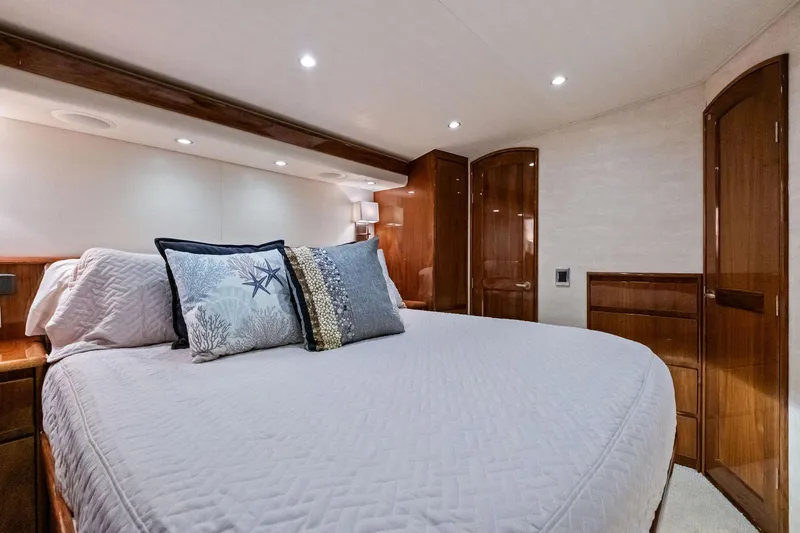 Slide: The Image of Luxurious bedroom interior of 2017 Viking 62 Enclosed Bridge yacht with elegant wood finishes. - 34