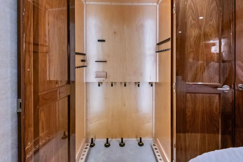 Slide: The Image of Interior of 2017 Viking 62 Enclosed Bridge yacht with wooden cabinetry and storage space. - 36