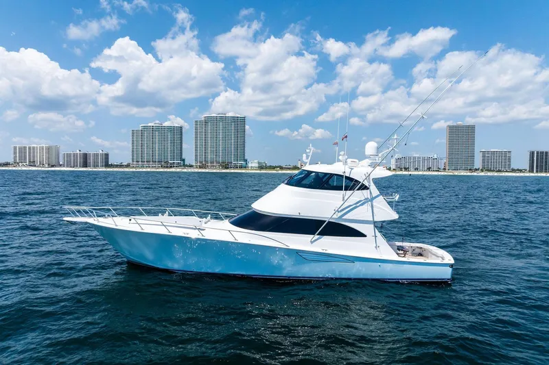 Slide: The Image of 2017 Viking 62 Enclosed Bridge yacht cruising near city skyline on a sunny day. - 4