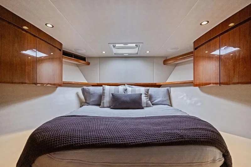 Slide: The Image of Luxurious bedroom interior of 2017 Viking 62 Enclosed Bridge yacht with elegant wood cabinetry. - 40
