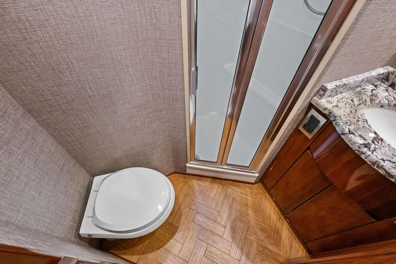 Slide: The Image of Luxurious bathroom in 2017 Viking 62 Enclosed Bridge yacht with modern fixtures. - 49