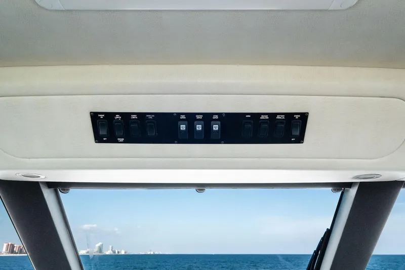 Slide: The Image of Control panel inside 2017 Viking 62 Enclosed Bridge yacht with ocean view. - 57