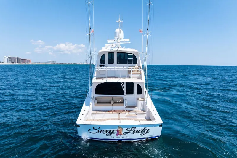 Slide: The Image of 2017 Viking 62 Enclosed Bridge yacht on open sea, clear sky, rear view. - 6