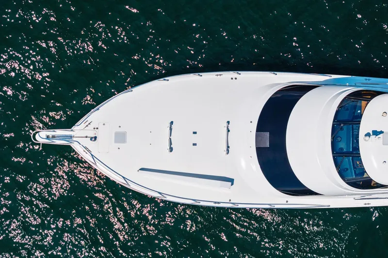 Slide: The Image of Aerial view of 2017 Viking 62 Enclosed Bridge yacht on sparkling water. - 65