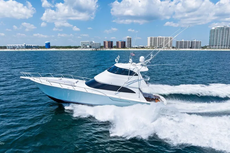 Slide: The Image of 2017 Viking 62 Enclosed Bridge yacht cruising on ocean near city skyline. - 71