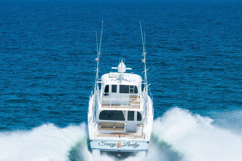 Slide: The Image of 2017 Viking 62 Enclosed Bridge yacht cruising on open ocean waters. - 72