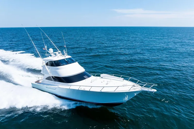 Slide: The Image of 2017 Viking 62 Enclosed Bridge yacht cruising on open ocean waters. - 76