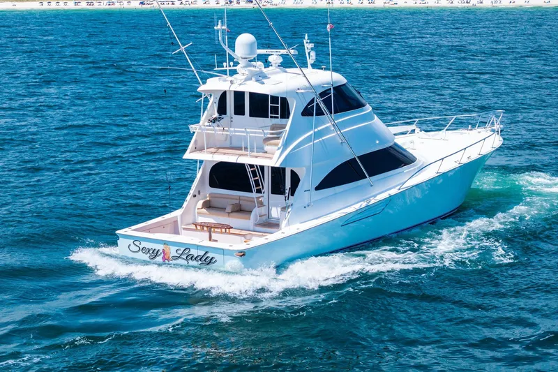 Slide: The Image of 2017 Viking 62 Enclosed Bridge yacht cruising on open water. - 8