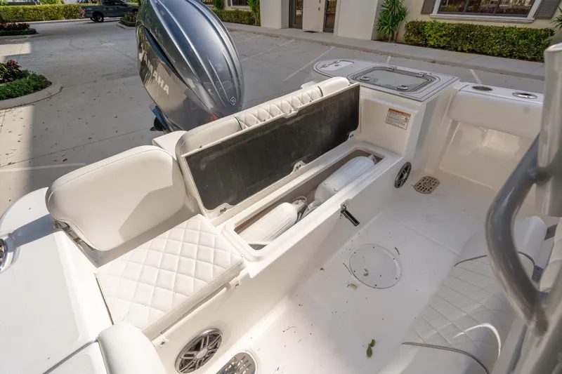 Slide: The Image of 2025 Sea Fox 228 Commander boat interior with Yamaha engine, featuring storage and seating. - 11