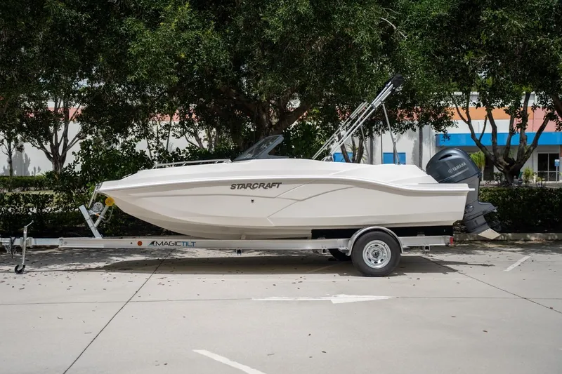 Slide: The Image of 2022 Starcraft SVX 190 DC boat on trailer, parked outdoors, side view. - 0