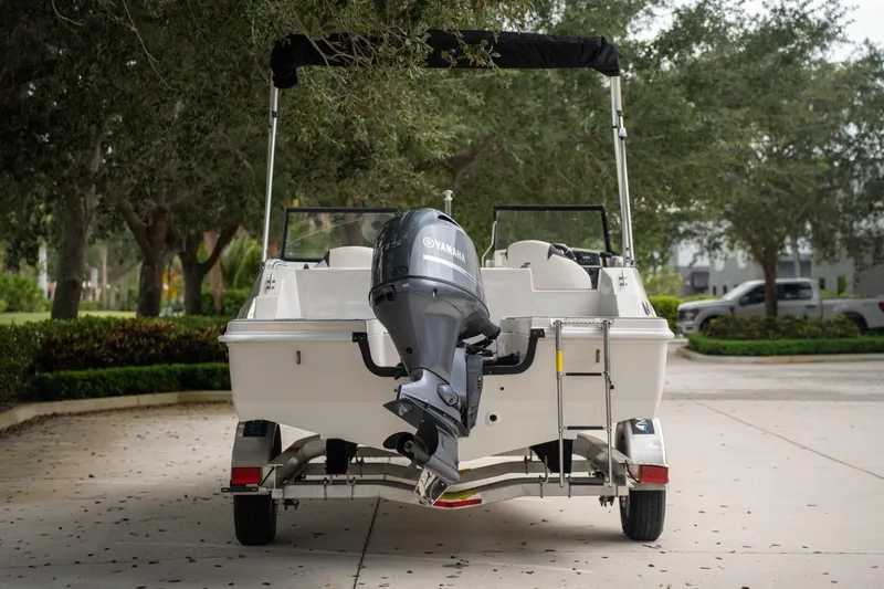 Slide: The Image of 2022 Starcraft SVX 190 DC boat with Yamaha outboard motor on trailer, parked outdoors. - 8