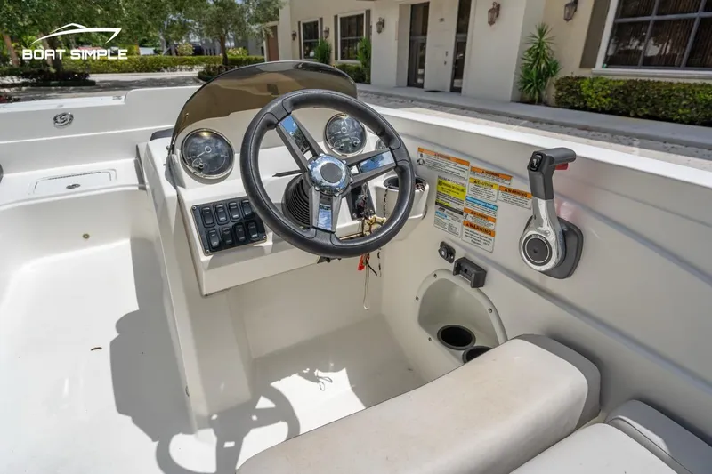 Slide: The Image of 2021 Hurricane SunDeck Sport 205 OB boat cockpit with steering wheel and controls. - 10
