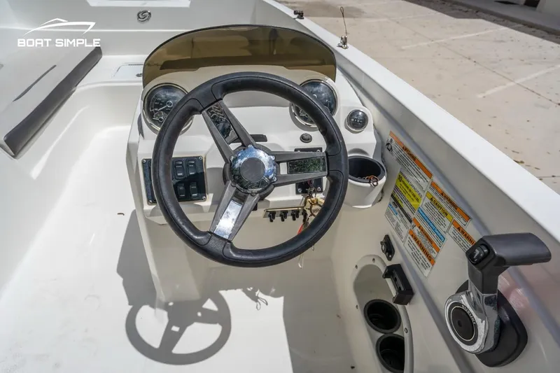Slide: The Image of 2021 Hurricane SunDeck Sport 205 OB boat dashboard with steering wheel and controls. - 7