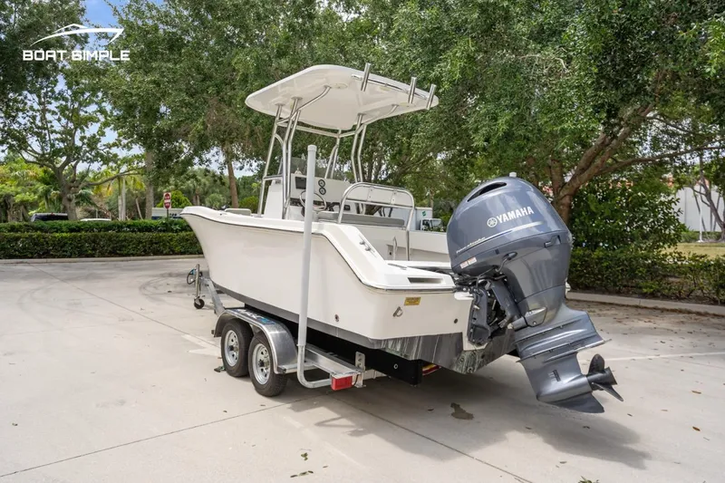 Slide: The Image of 2020 Release 210 RX boat on trailer with Yamaha outboard motor, parked outdoors. - 5