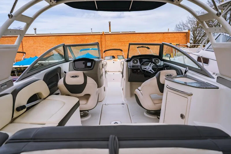 Slide: The Image of 2018 Chaparral 224 Sunesta boat interior with seating and steering console. - 2