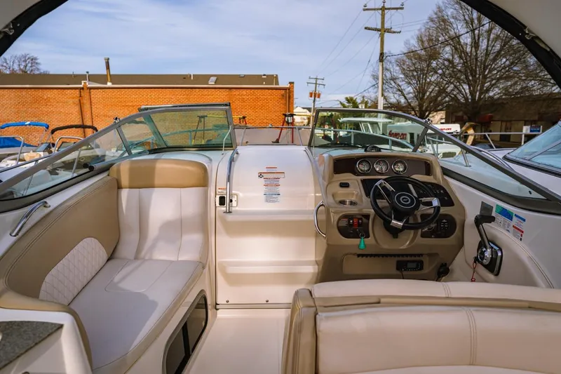 Slide: The Image of 2018 Chaparral 270 Signature boat interior with steering wheel and seating area. - 1