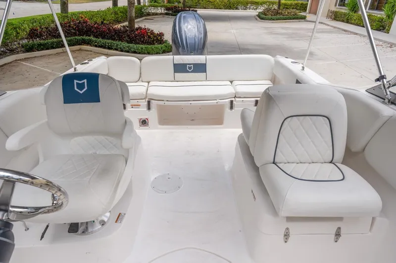 Slide: The Image of 2025 Sea Fox 228 Traveler boat interior with white seating and steering wheel. - 7