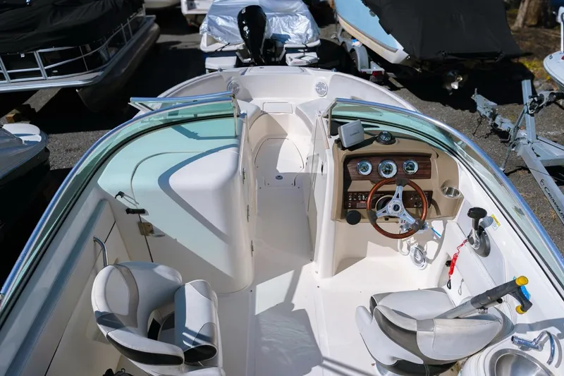 Slide: The Image of 2012 Sea Ray 240 Sundeck boat interior with steering wheel and seating. - 5