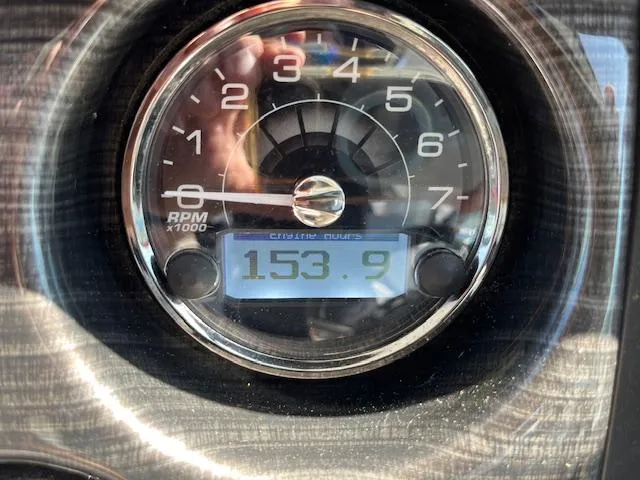 Slide: The Image of Tachometer of 2022 Monterey 295 Sport Yacht showing 153.9 hours. - 12