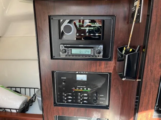 Slide: The Image of Control panel of 2022 Monterey 295 Sport Yacht with audio system and switches. - 26