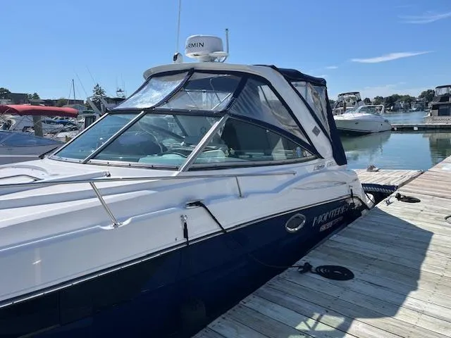 Slide: The Image of 2022 Monterey 295 Sport Yacht docked at marina under clear blue sky. - 4