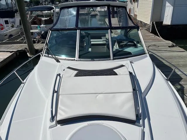 Slide: The Image of 2022 Monterey 295 Sport Yacht docked, showcasing sleek design and spacious deck. - 8