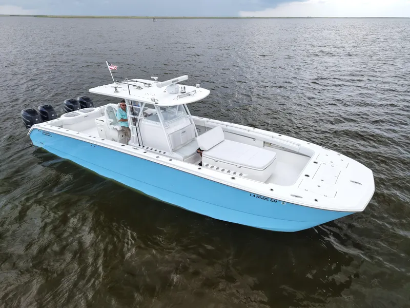 Slide: The Image of Invincible 40 Catamaran 2018 on open water, featuring sleek design and multiple engines. - 10