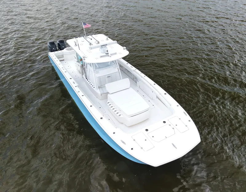 Slide: The Image of 2018 Invincible 40 Catamaran on water, aerial view, white and blue design. - 11