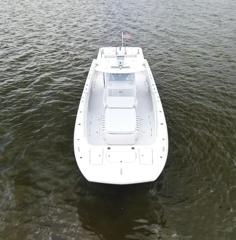 Slide: The Image of 2018 Invincible 40 Catamaran on water, aerial view, white hull, American flag. - 12