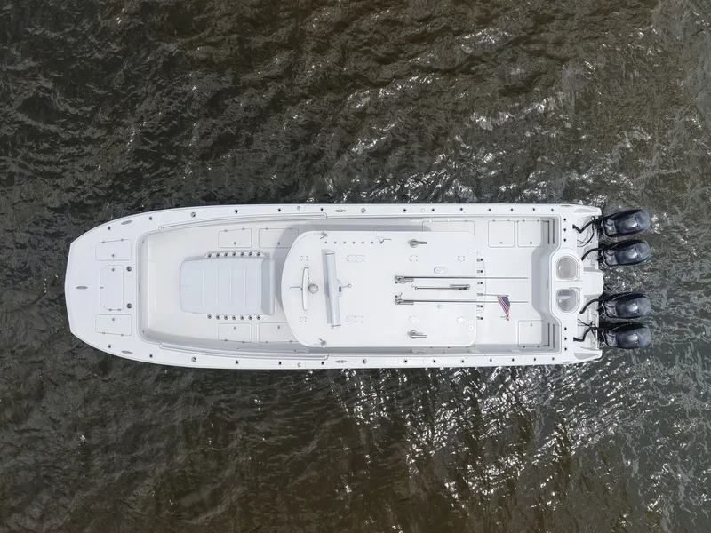Slide: The Image of Overhead view of a 2018 Invincible 40 Catamaran on water, featuring triple outboard engines. - 14