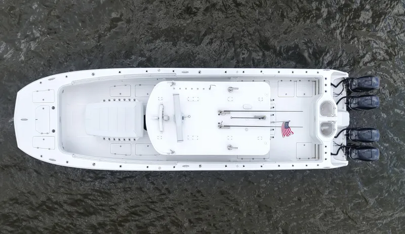 Slide: The Image of Overhead view of 2018 Invincible 40 Catamaran on water, featuring sleek design and multiple engines. - 15