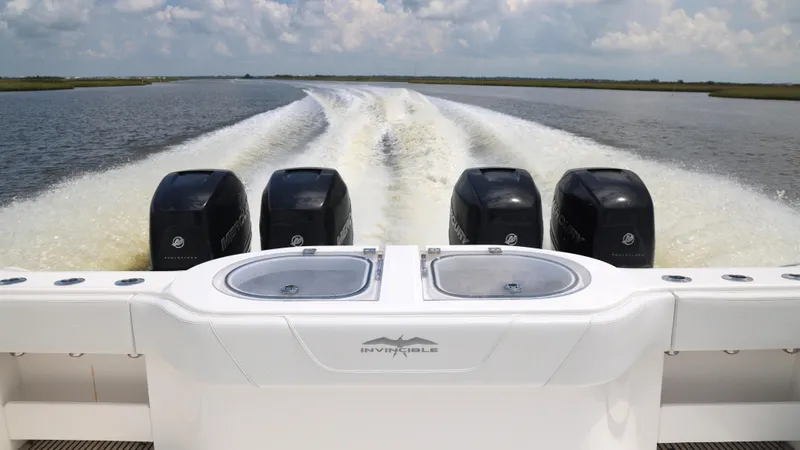 Slide: The Image of Invincible 40 Catamaran 2018 cruising with four powerful engines on open water. - 17