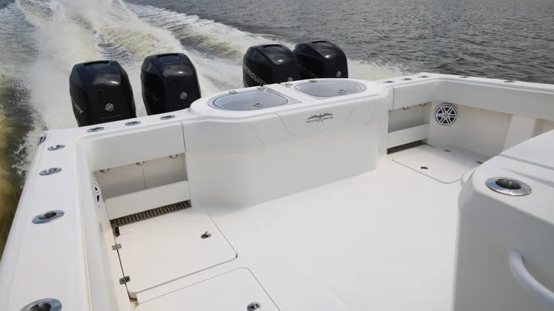 Slide: The Image of 2018 Invincible 40 Catamaran with four outboard engines cruising on water. - 18