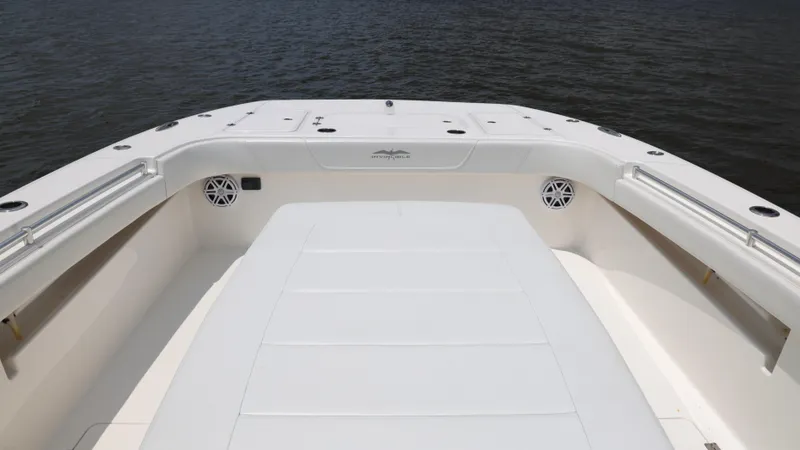 Slide: The Image of Invincible 40 Catamaran 2018, spacious deck view, white finish, on calm water. - 19