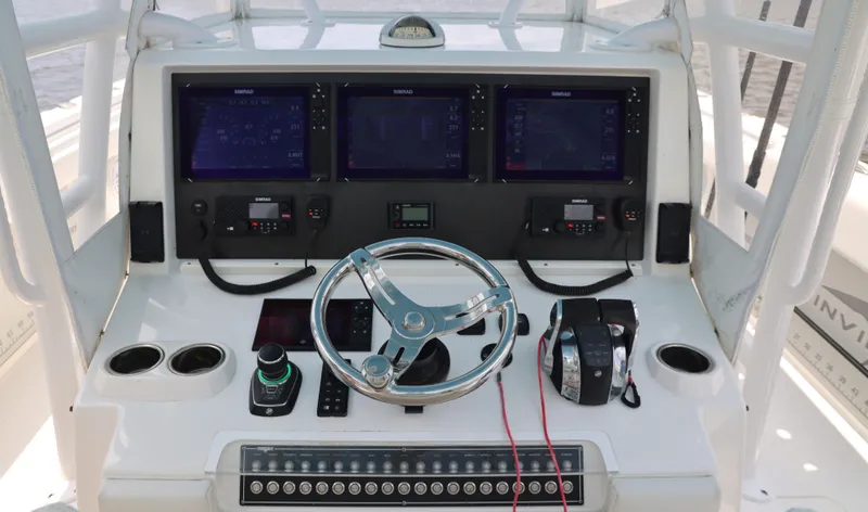 Slide: The Image of Cockpit of 2018 Invincible 40 Catamaran with advanced navigation and control systems. - 25
