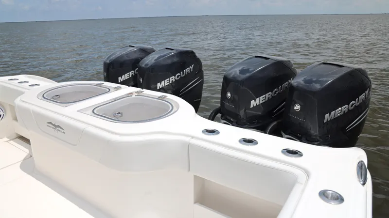 Slide: The Image of 2018 Invincible 40 Catamaran with four Mercury outboard engines on open water. - 26