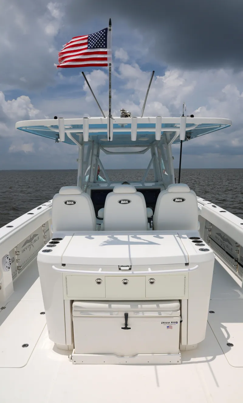 Slide: The Image of Invincible 40 Catamaran 2018 with American flag, ocean backdrop, and cloudy sky. - 27