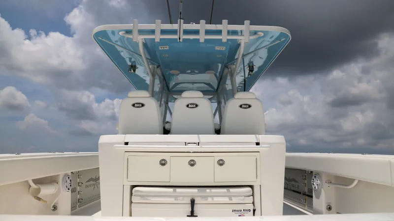 Slide: The Image of 2018 Invincible 40 Catamaran interior with seating and storage under cloudy sky. - 28