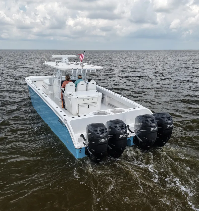 Slide: The Image of 2018 Invincible 40 Catamaran with quad Mercury 350 engines cruising on open water. - 4