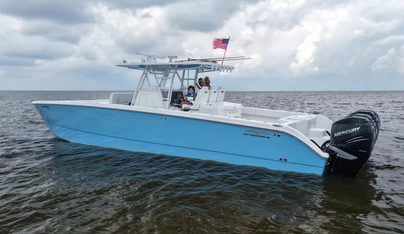 Slide: The Image of 2018 Invincible 40 Catamaran with Mercury engines on open water, American flag flying. - 6