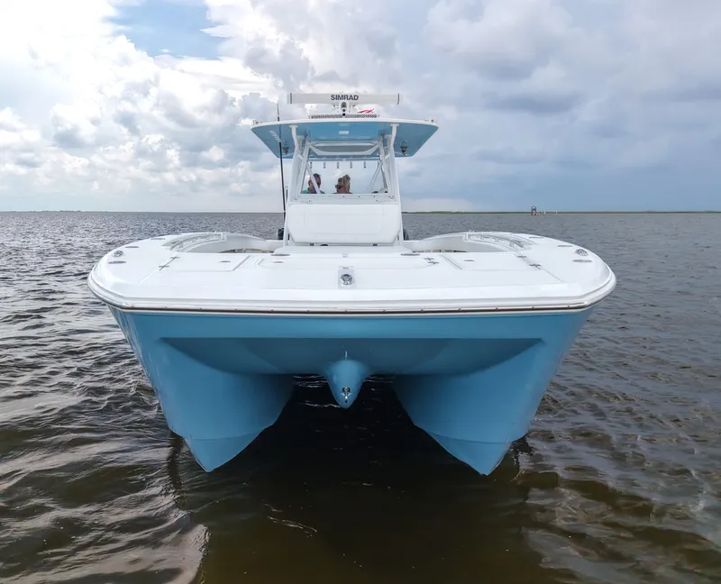 Slide: The Image of 2018 Invincible 40 Catamaran on water, showcasing sleek design and blue hull. - 8