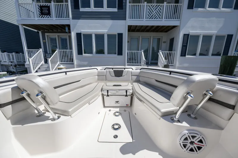 Slide: The Image of 2019 Wellcraft 352 Fisherman boat interior with seating, near waterfront homes. - 14