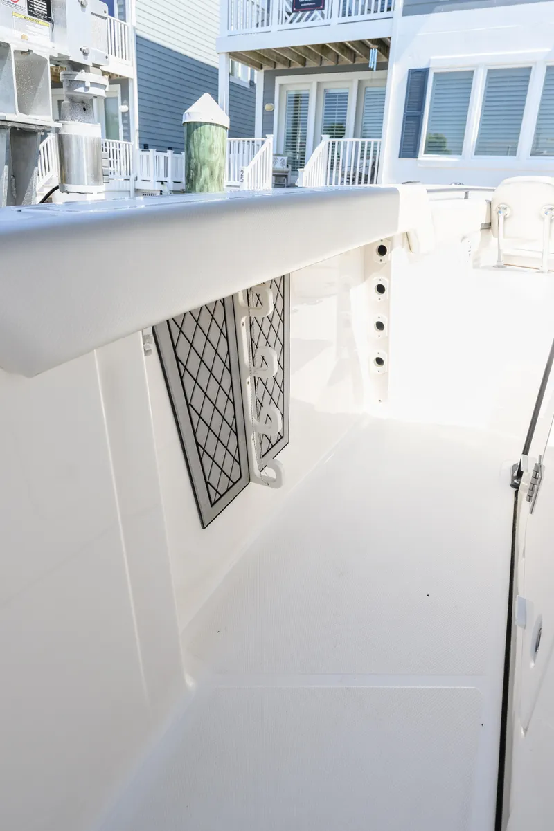 Slide: The Image of 2019 Wellcraft 352 Fisherman boat interior with clean white deck and storage compartments. - 16
