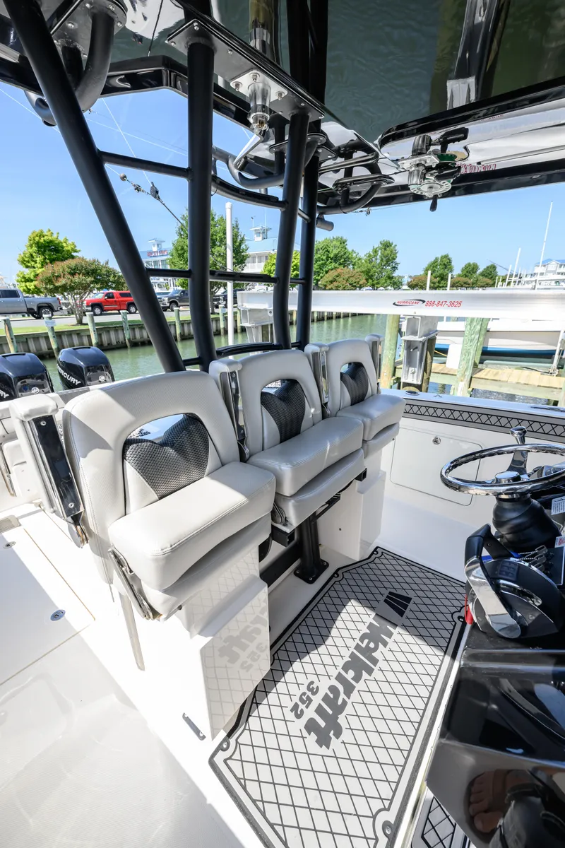 Slide: The Image of 2019 Wellcraft 352 Fisherman boat interior with cushioned seating and steering console. - 18