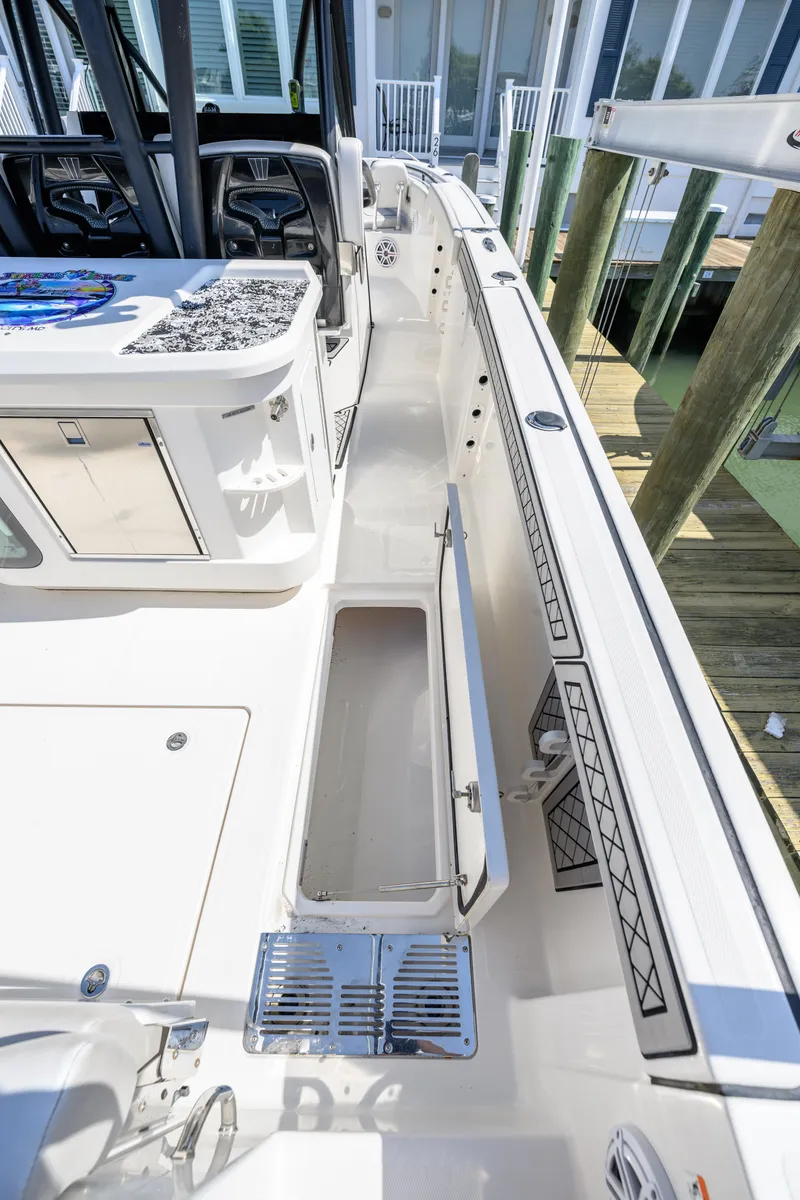 Slide: The Image of 2019 Wellcraft 352 Fisherman boat deck with open storage compartment and seating area. - 23