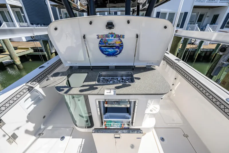 Slide: The Image of 2019 Wellcraft 352 Fisherman boat with open storage and sink area. - 26