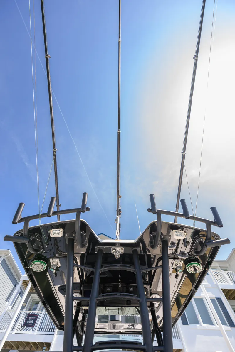 Slide: The Image of 2019 Wellcraft 352 Fisherman boat, view of fishing rods and equipment against a clear blue sky. - 28