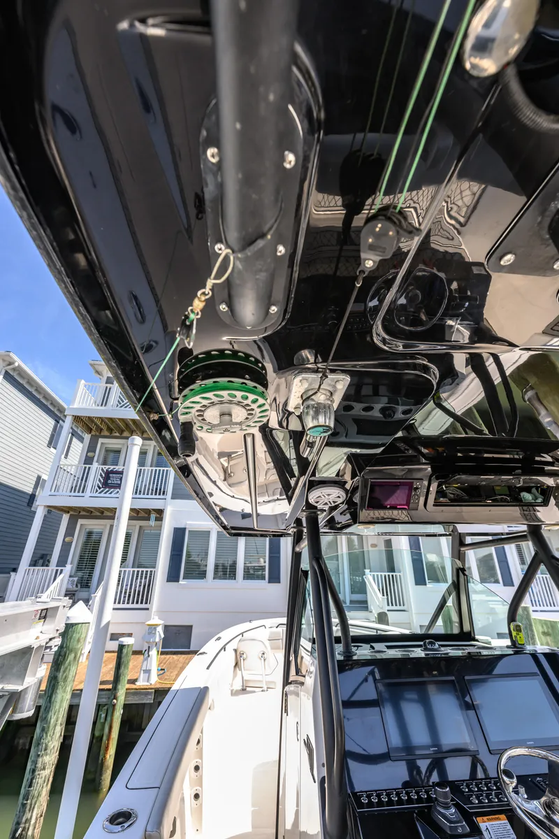 Slide: The Image of 2019 Wellcraft 352 Fisherman boat interior with advanced navigation equipment and fishing gear. - 30