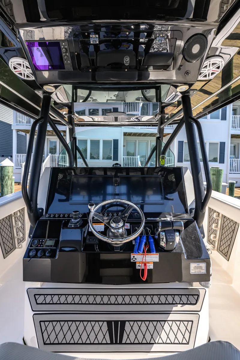 Slide: The Image of 2019 Wellcraft 352 Fisherman boat dashboard with steering wheel and controls. - 33