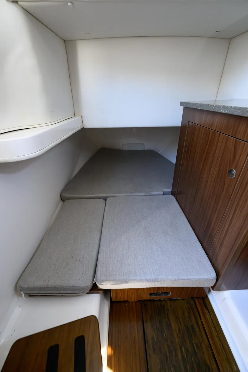 Slide: The Image of 2019 Wellcraft 352 Fisherman cabin interior with cushioned seating and wooden cabinetry. - 36